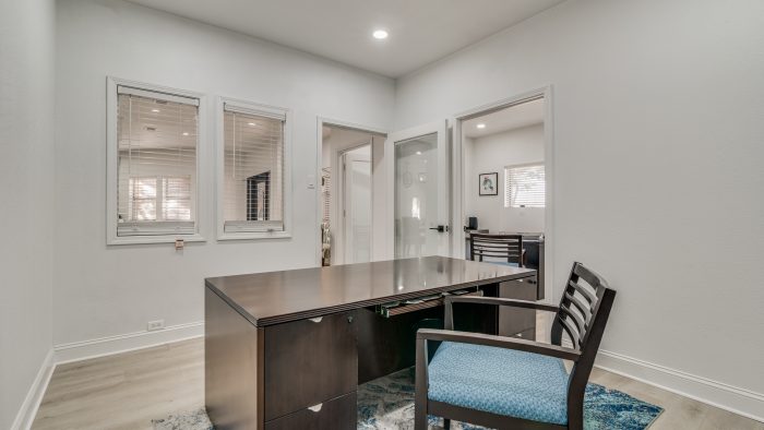 a home office with a desk and chair at The Falltree Apartments